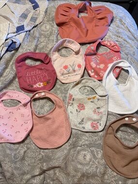 Lot of baby necessities: bibs, towels, washcloths, burp cloths, and owl blanket